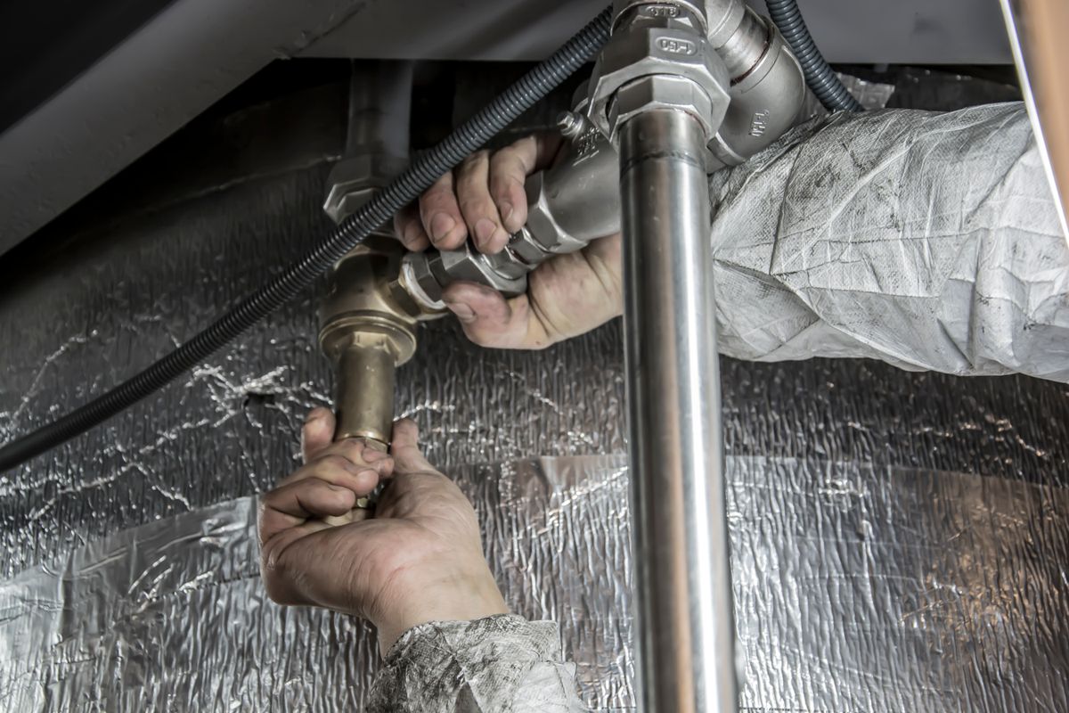Plumber inspecting a residential water heater